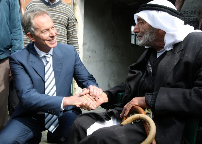Tony Blair shakes hands with Palestinian during visit to West Bank village of Beit Skarya cp 1